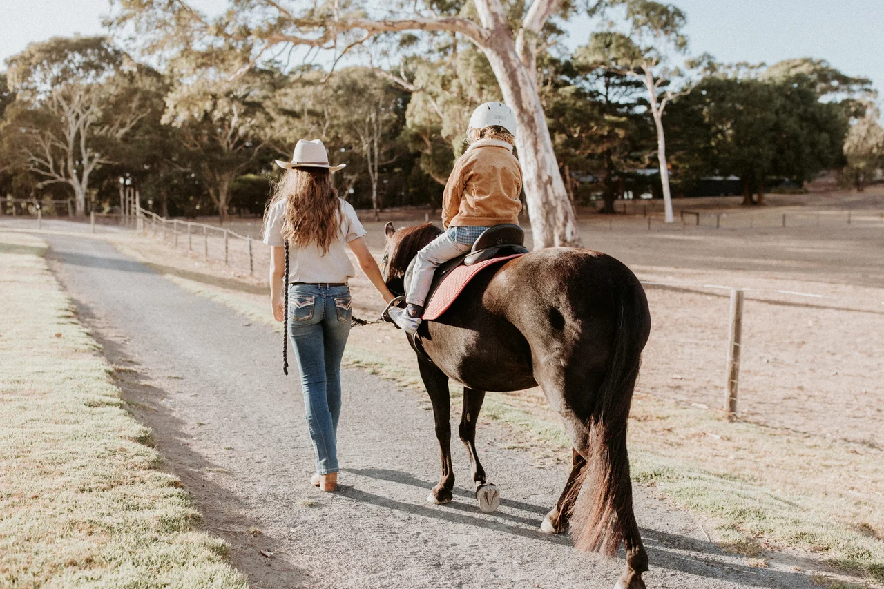 Child enjoying supervised pony ride at Hahndorf Farm Barn